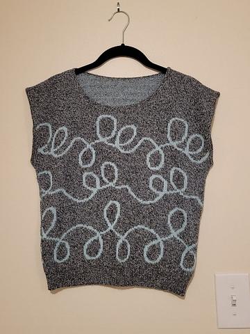 Sweater vest with swirly blue lines