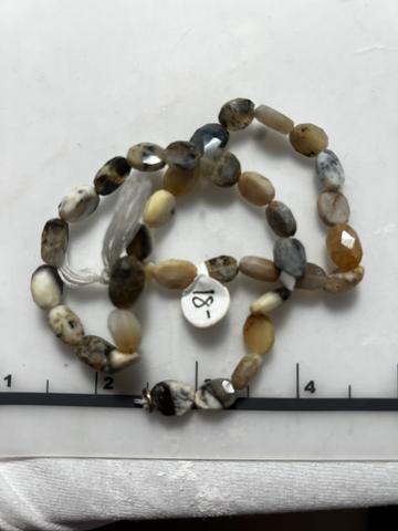 One 15.5 inch strand of neutral agate oval faceted beads