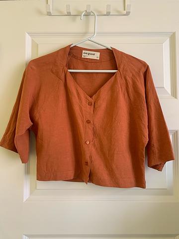 Eve Gravel orange blouse