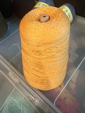 Cone of yellow yarn